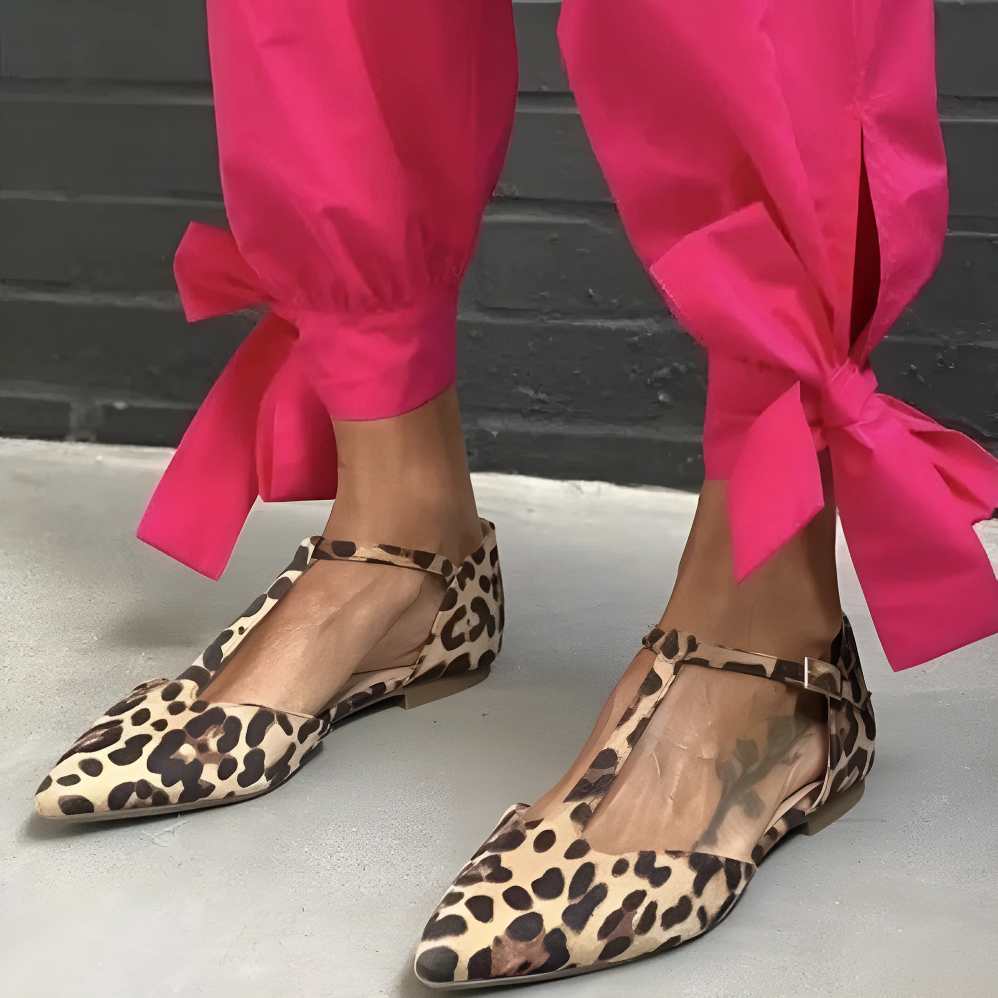 Women's leopard print pointed toe pumps with a low chunky heel and cross shoulder straps.