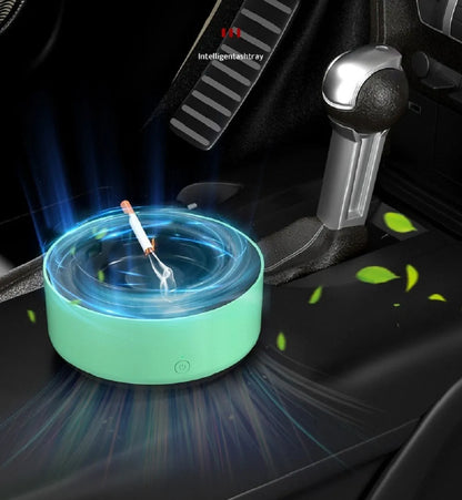Grey intelligent electronic air purifier ashtray with fan, shown on a desk next to a cigarette.