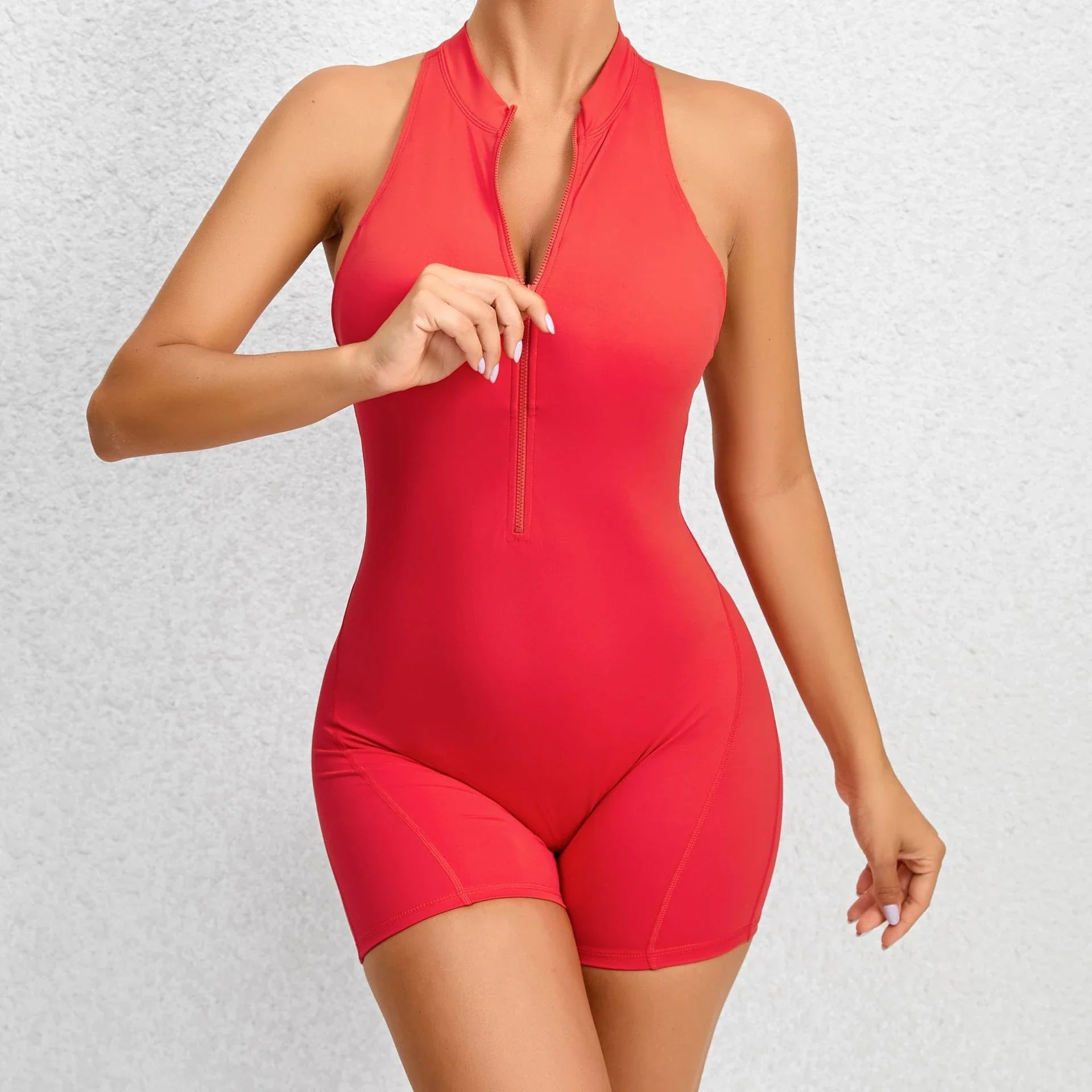 Stylish and functional zippered yoga jumpsuit with stretchy and breathable fabric, available in a variety of vibrant colors