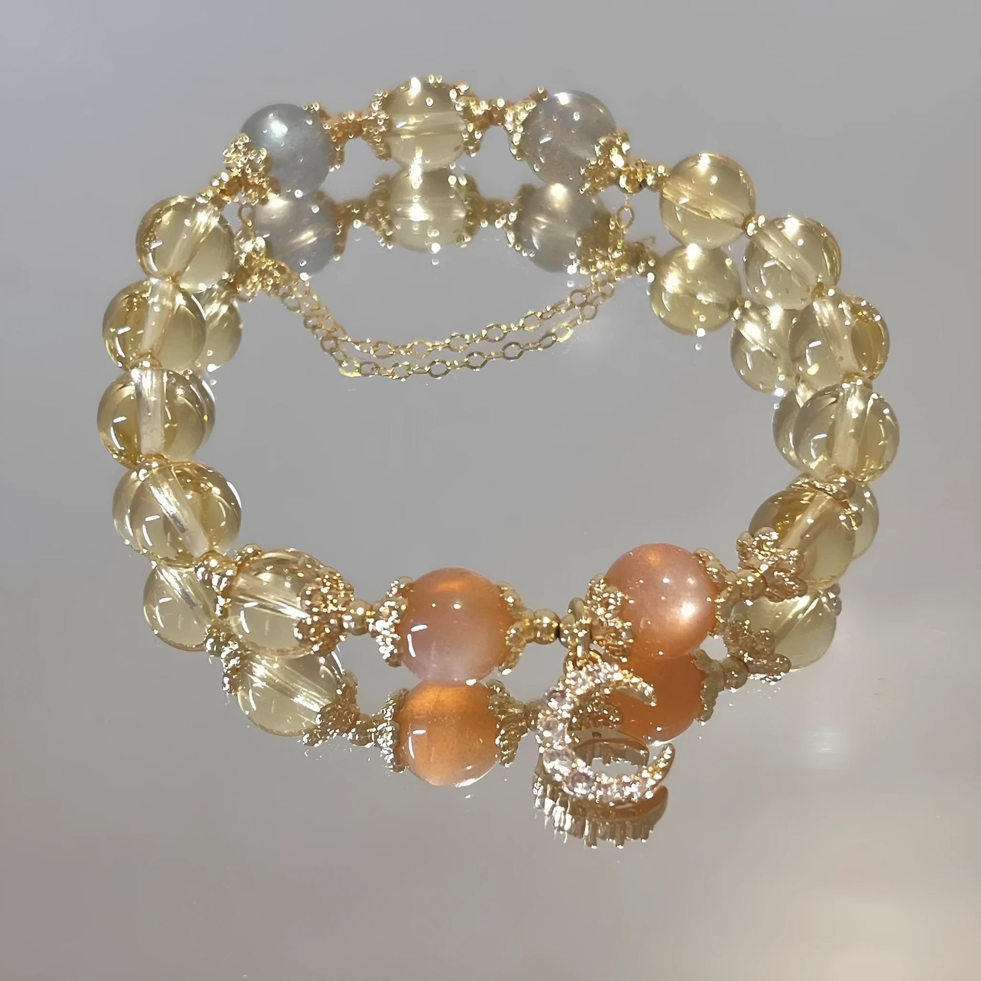 Women's gold electroplated crystal bracelet with moonstone and sunstone stones in Chinese style design.