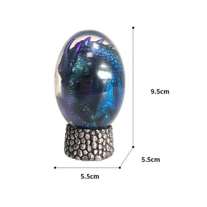 A lifelike resin dragon egg ornament with a crystal-clear, transparent design, sitting on a glowing lava-style base.