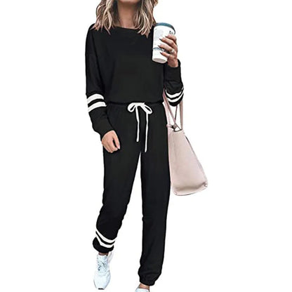 Women's loose-fitting plus size casual suit in a cotton blend, shown in a solid colour with a half-sleeve top and trousers.