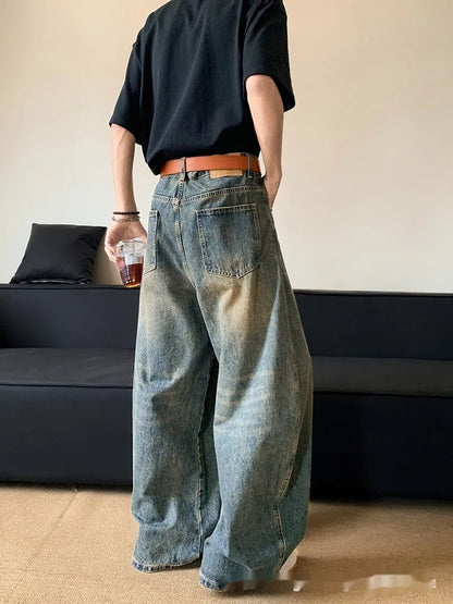 Men's distressed retro blue jeans with a slim wide-leg cut and mid waist.
