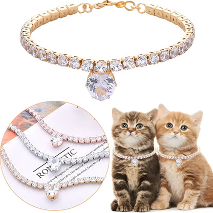 A heart-shaped rhinestone pendant on a gold plated adjustable collar for a small dog, showing the buckle and extension chain.