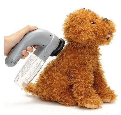 Grey handheld electric pet hair remover brush with soft rubber head for grooming dogs and cats.