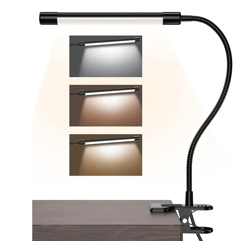 Black adjustable gooseneck desk lamp with USB cable bent over a notebook on a wooden desk.