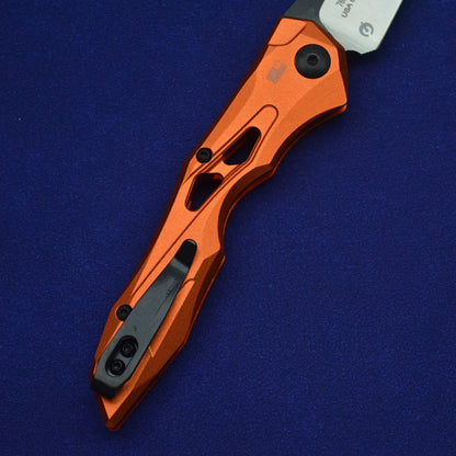 Black folding fruit knife with D2 steel blade and aluminium handle, shown open with length scale.