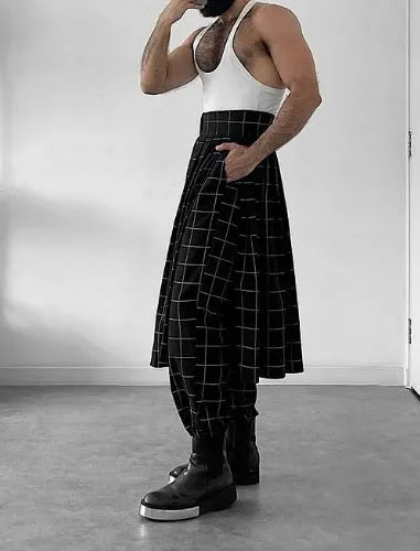 Man wearing grey plaid trousers with a distinctive apron-front design detail.