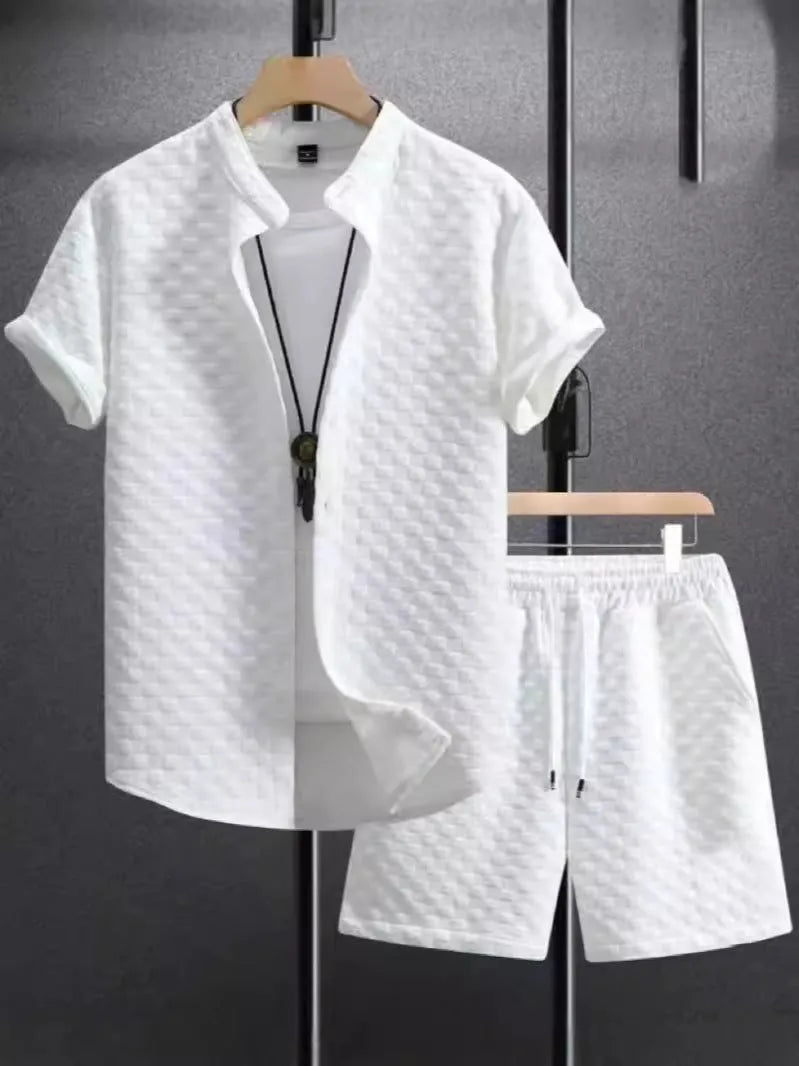 Man wearing a black and white jacquard short sleeve shirt and matching shorts suit set.