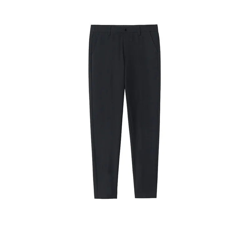 Man wearing black slim straight-leg loose fit cotton trousers with a drawstring waist