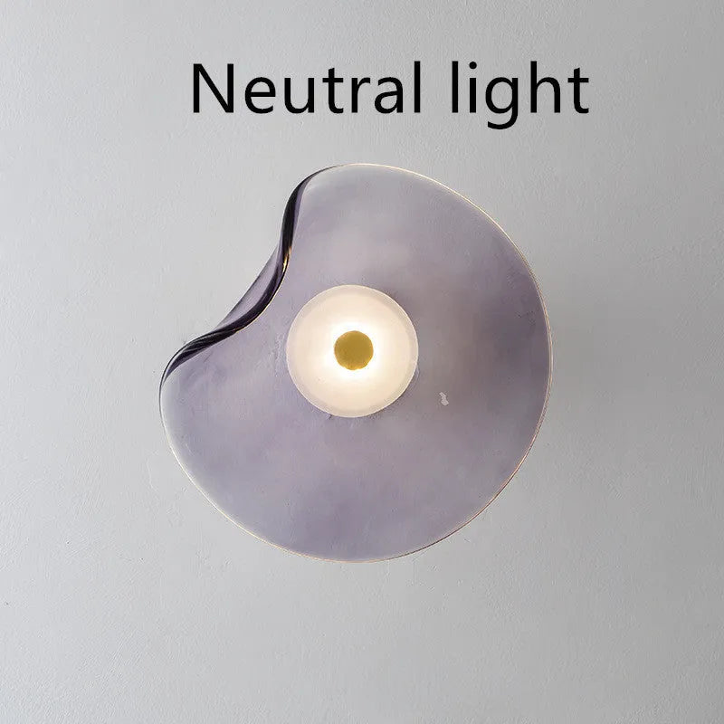 Round glass wall lamp mounted beside bed in cognac colour with 220V operation for bedside lighting