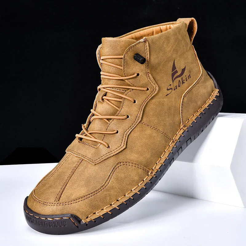 A pair of beige high-top casual boots with elastic band fastening and a flat rubber sole.