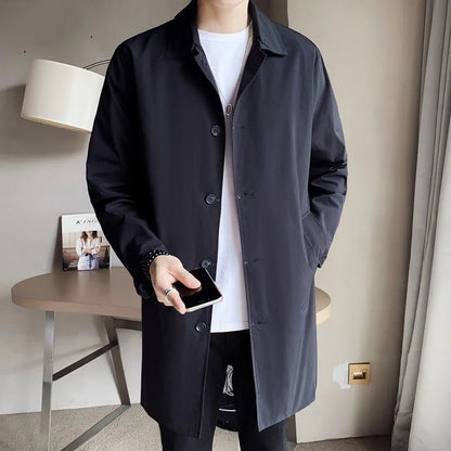 Man wearing a khaki coloured loose fit mid-length trench coat made from rabbit fur fabric.