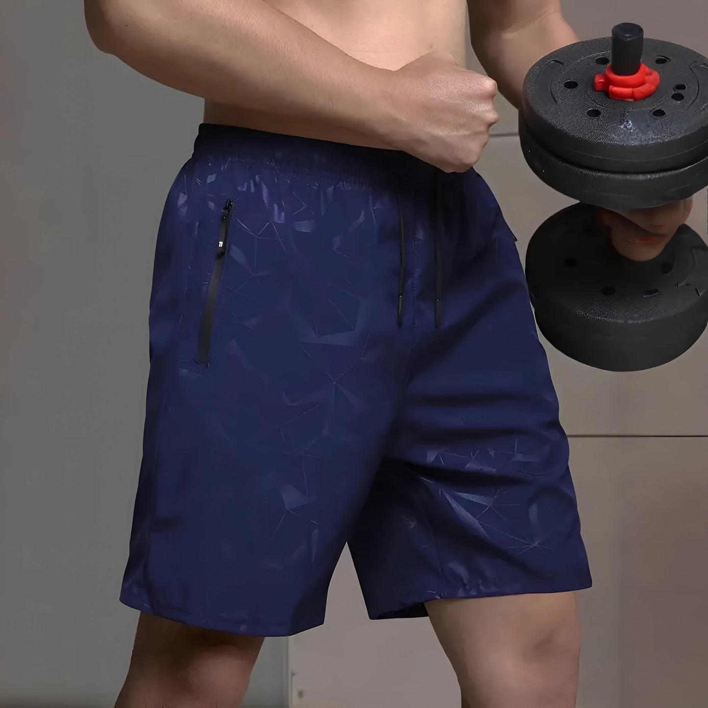 Man wearing loose-fit grey printed sports shorts with elastic waistband, showcasing the above-knee length.