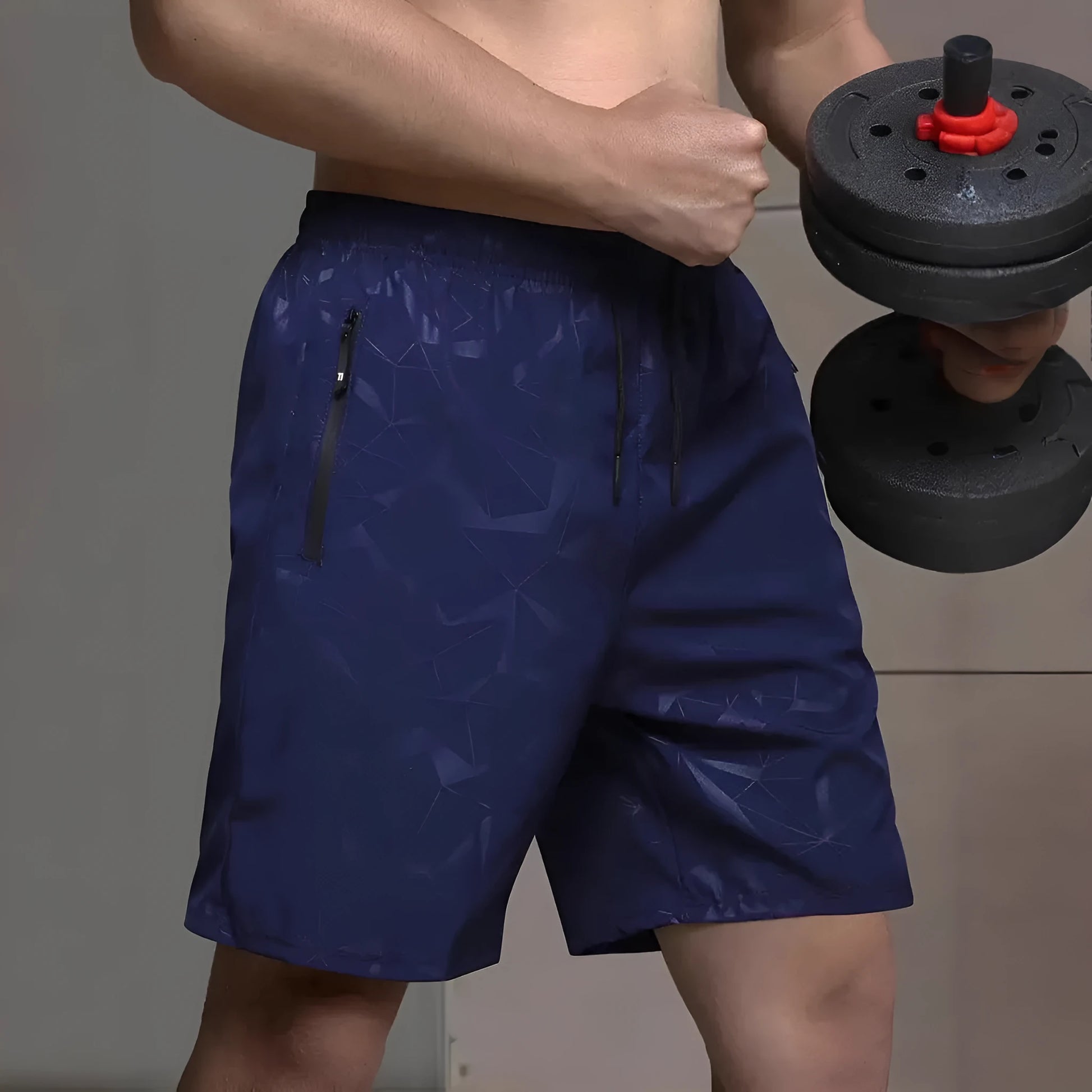 Man wearing loose-fit grey printed sports shorts with elastic waistband, showcasing the above-knee length.
