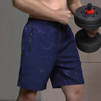 Man wearing loose-fit grey printed sports shorts with elastic waistband, showcasing the above-knee length.