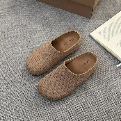 Baotou Boken women's cloth upper slippers with rubber sole in beige, shown in a leisure setting.