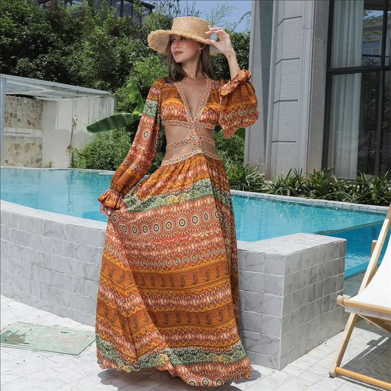Elegant floral print dress with long sleeves and empire waistline in vibrant orange color