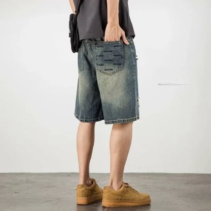 Men's blue loose fit denim shorts with distressed holes and straight leg
