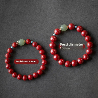 Purple Gold Sand cinnabar bracelet with geometric ellipse beads and a metal clasp on a wrist.