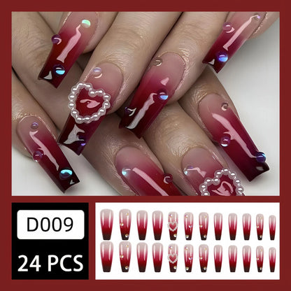 Set of long false nail tips with wine red gradient colour, plaid pattern, and a pearl heart design.