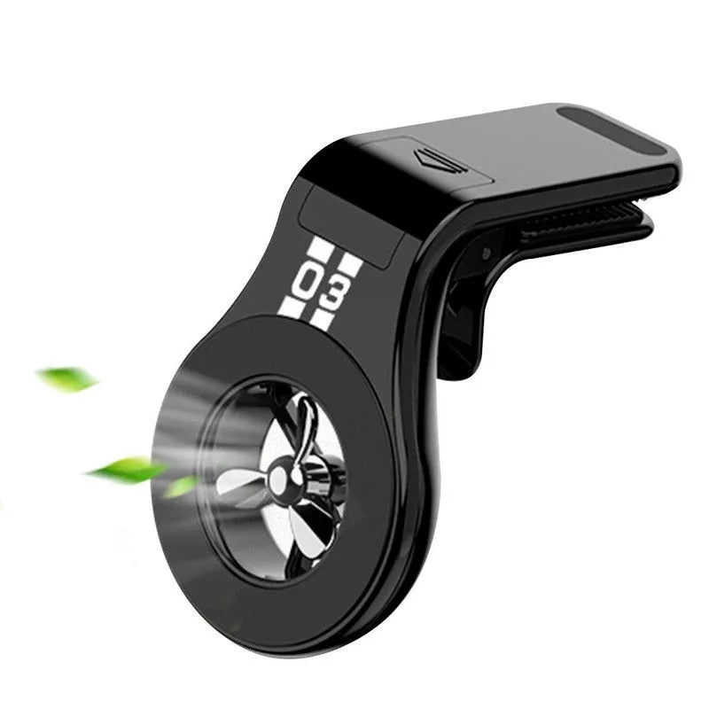 Black magnetic car phone holder attached to air vent with phone mounted and fragrance slice visible