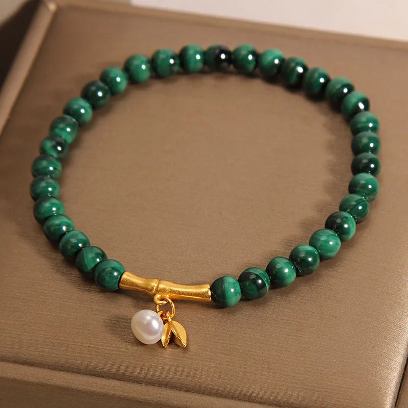 Close-up of a women's adjustable white crystal bracelet featuring a high-rise lucky bamboo design on a wrist.
