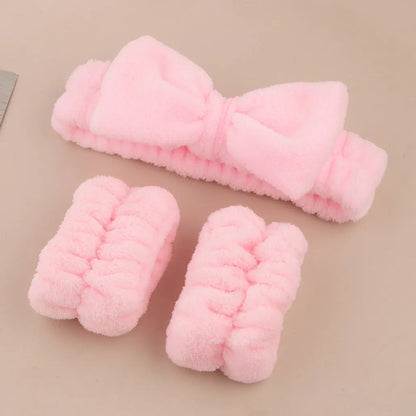 Facial brush set with coral fleece hair band and four nylon-bristle brushes in purple, grey, white, or pink colours