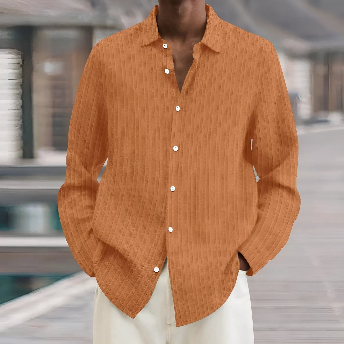 Man wearing a loose fit plain colour striped long sleeve cardigan shirt.