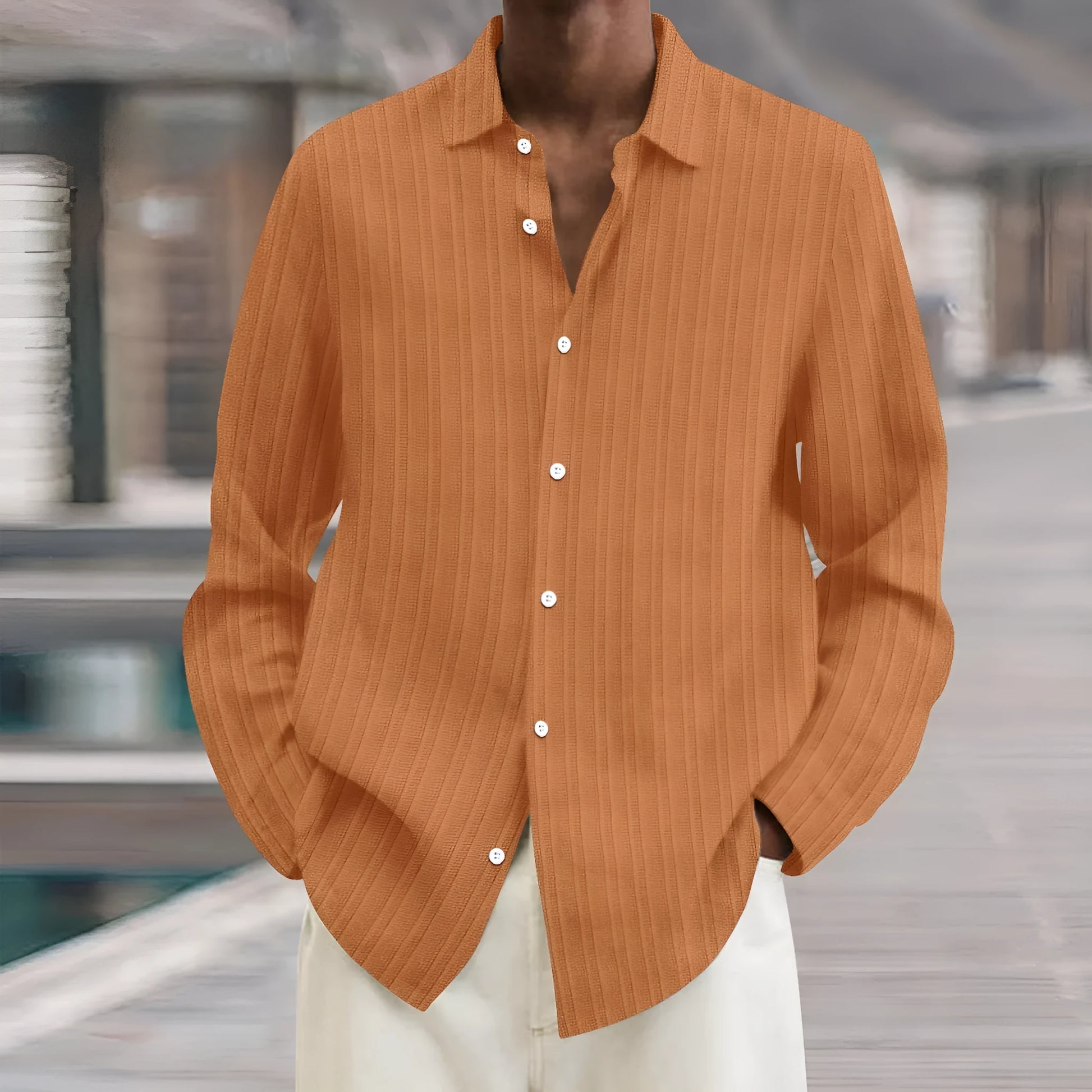 Man wearing a loose fit plain colour striped long sleeve cardigan shirt.