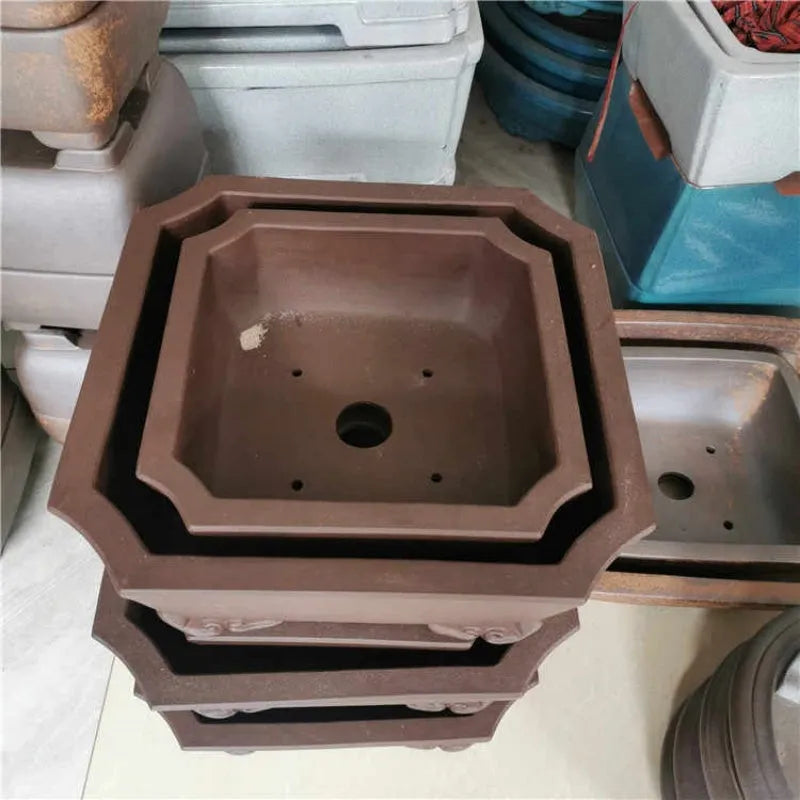 40cm square purple clay bonsai pot in brown, tree stump design, shown with plants on a tabletop