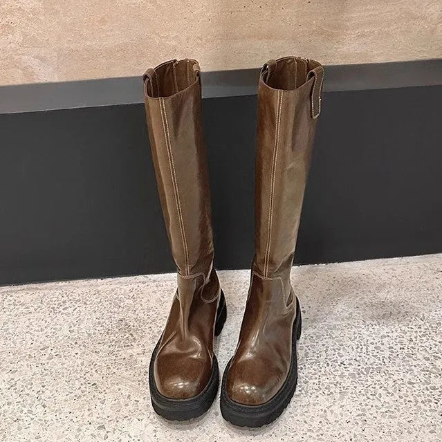 Round toe black chunky heel women's knight boots with a back zipper on a rubber sole.