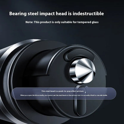 Gun grey aluminium car safety hammer with seatbelt cutter on a 3M rubber base next to a test glass.