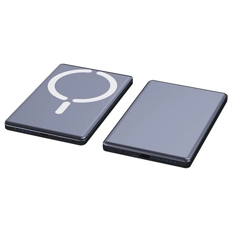 Slim dark grey magnetic power bank attached to the back of an iPhone, showing its thin profile and metallic finish.