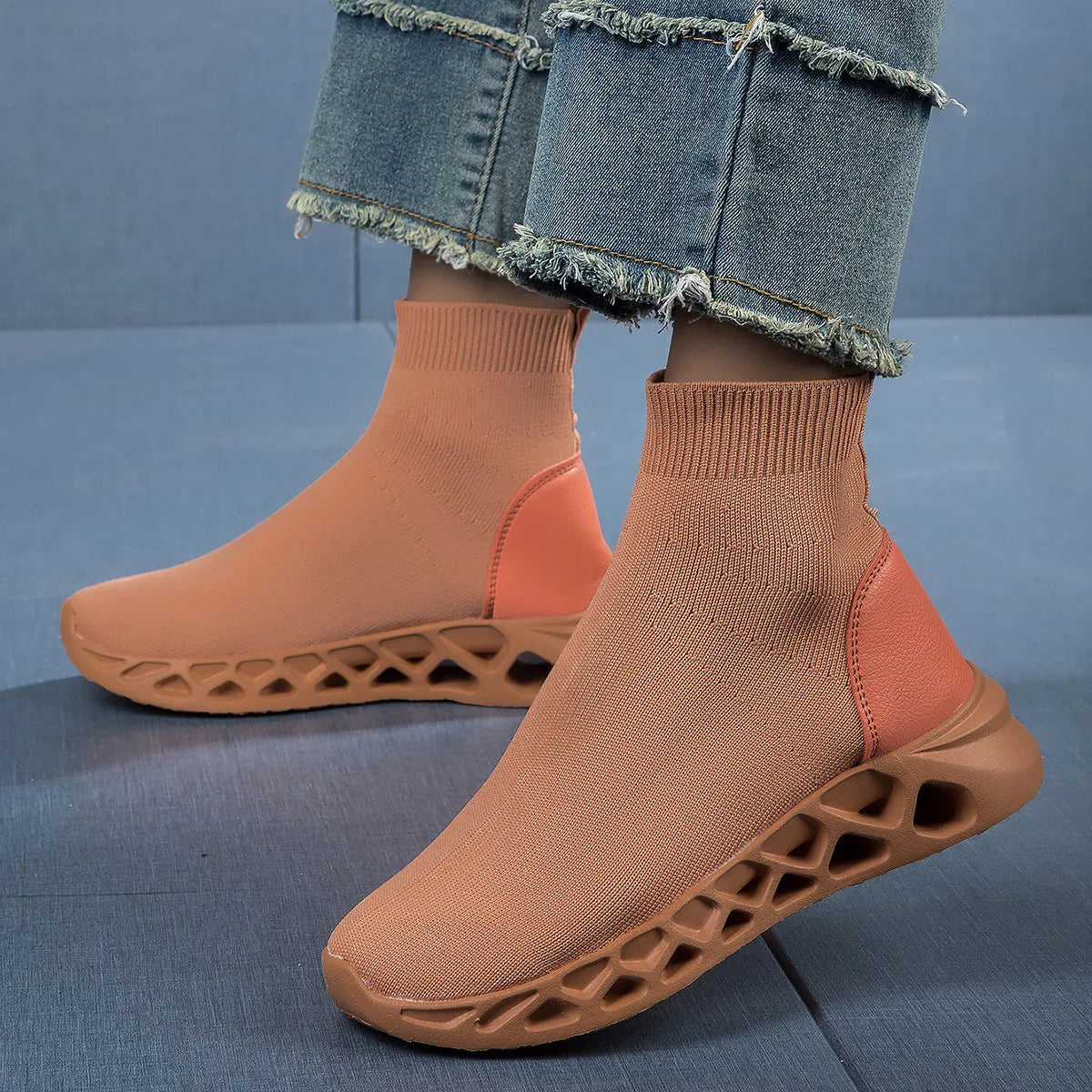 Women's casual mesh slip-on shoes in terracotta colour with flat sole and sewing line detail.