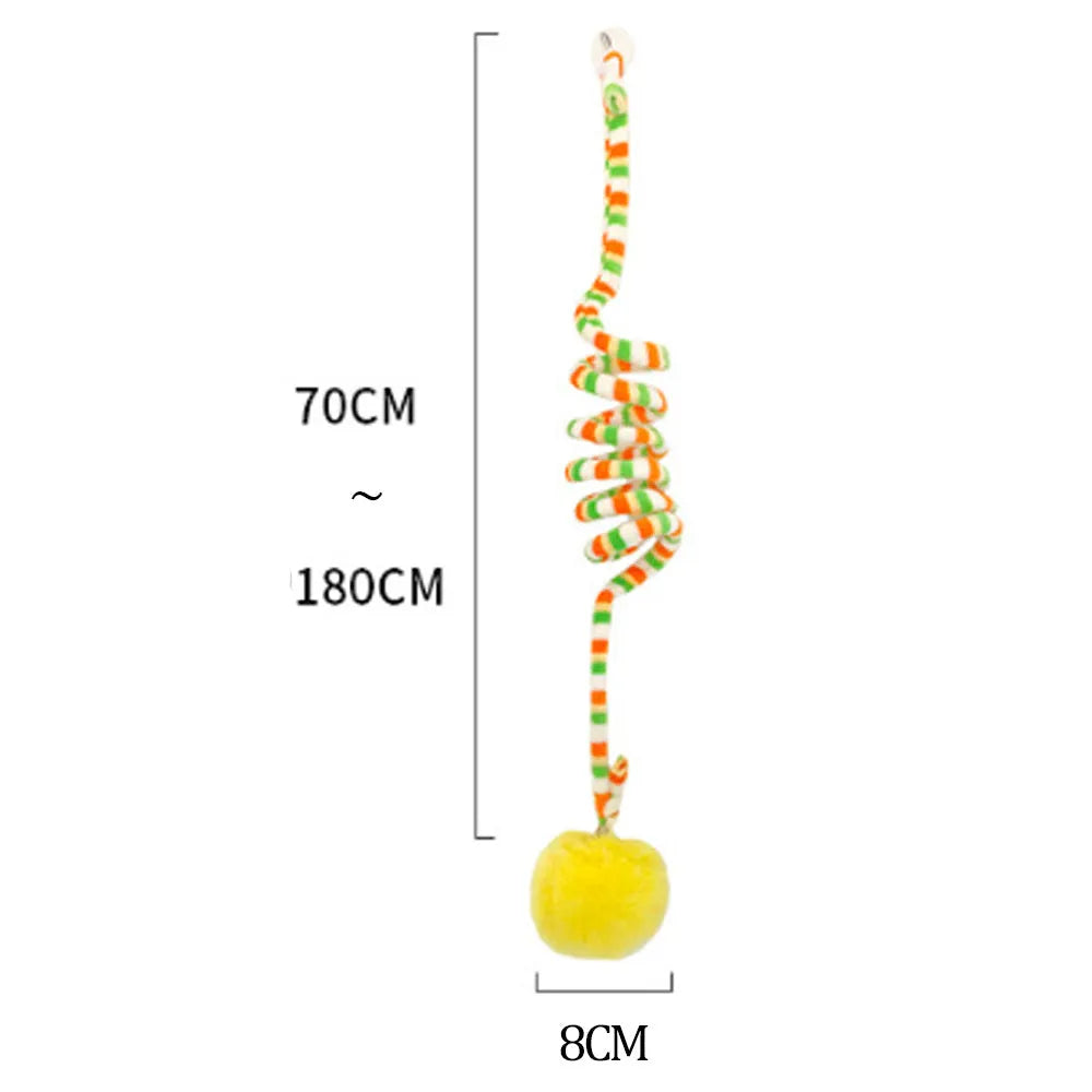 Hanging cat toy with spring, bell, and inflatable ball attached to a door via a suction cup.
