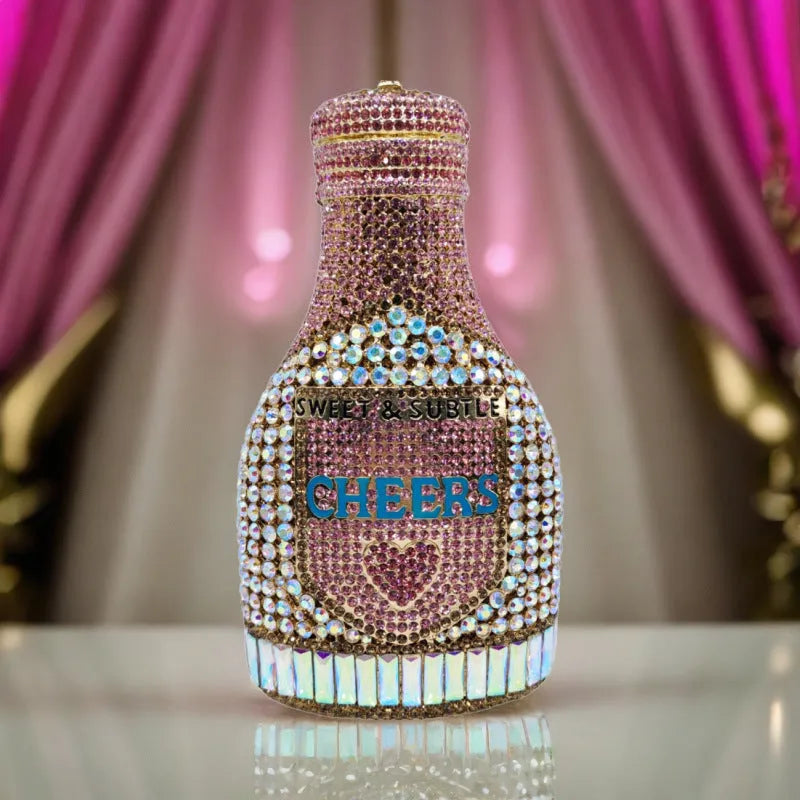 Gold hard-shell clutch bag shaped like a champagne bottle with a synthetic leather interior.