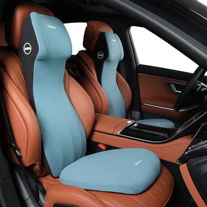 Black memory foam automotive waist cushion and matching headrest pillow set on a car seat.