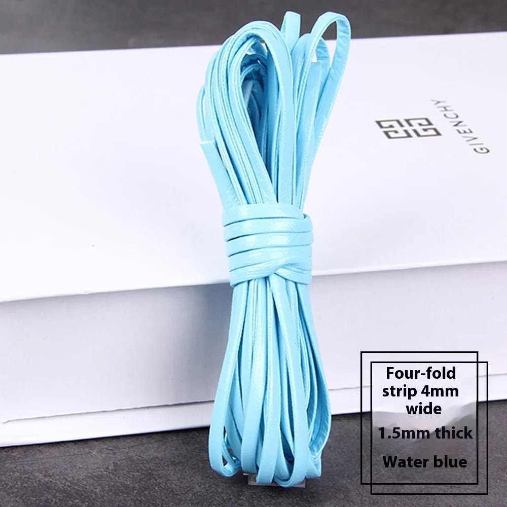 Coiled reels of PU leather craft string in multiple colours including beige, black, red, and blue.