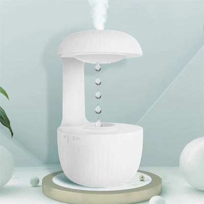 White anti-gravity humidifier showing water droplets appearing to levitate upwards from its base