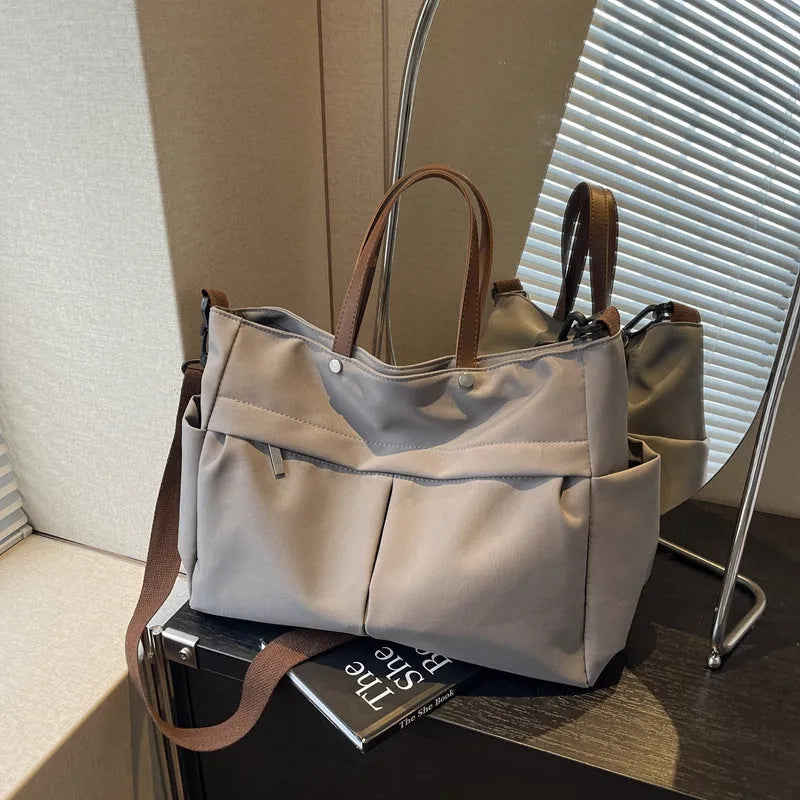 Nylon crossbody bag in five colours with 39x14x28cm dimensions and shoulder strap