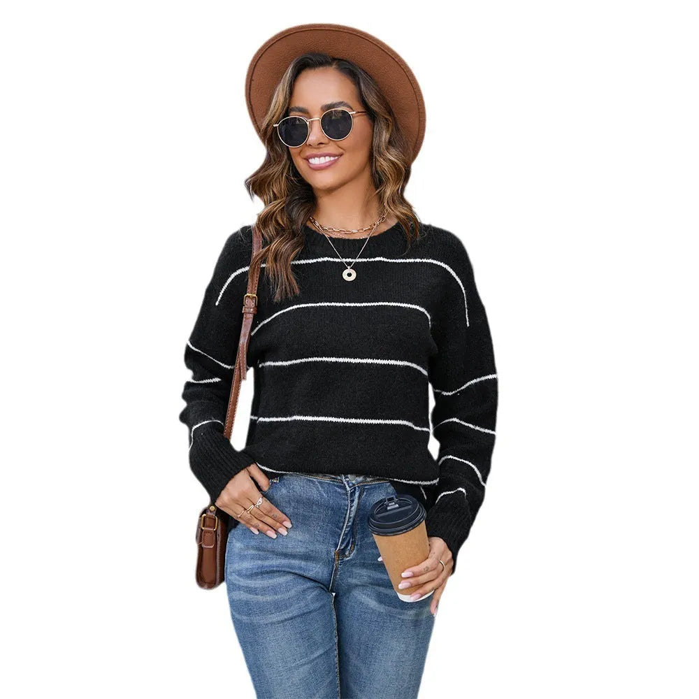 Women's black and white striped pullover sweater with round neck and loose fit.