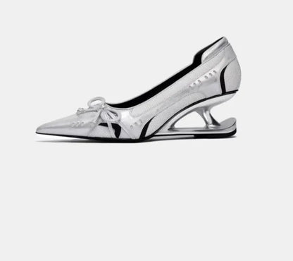Women's black pointed toe shoes with a distinctive floating Mary Jane heel.