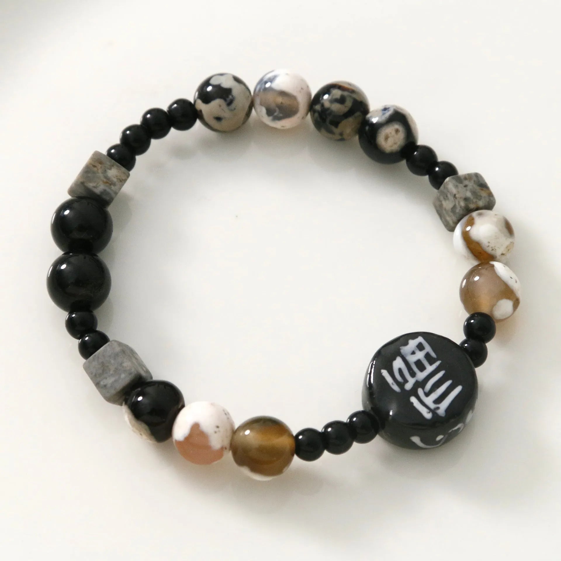 Hand-woven black agate ceramic bracelet with natural glitter stones and geometric design