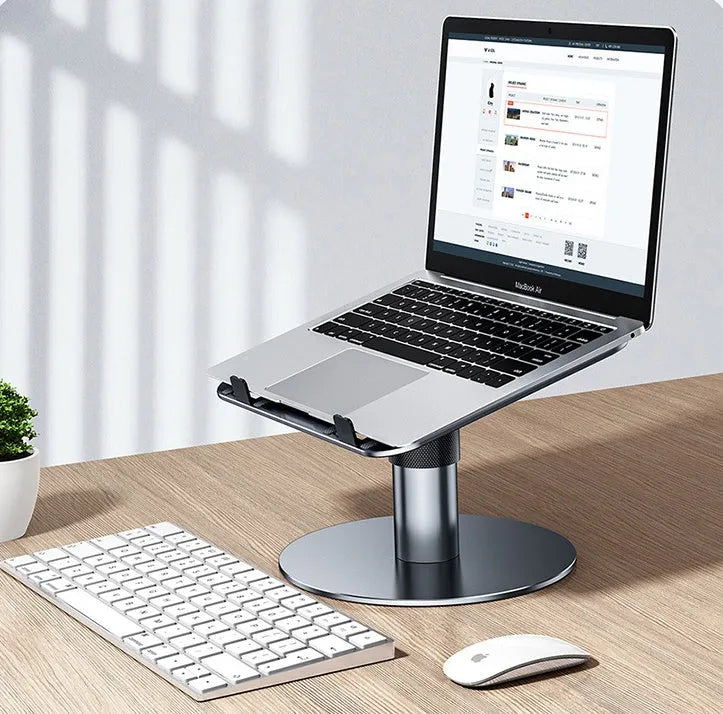 Silver adjustable aluminium car laptop stand with rotating base shown supporting a laptop.