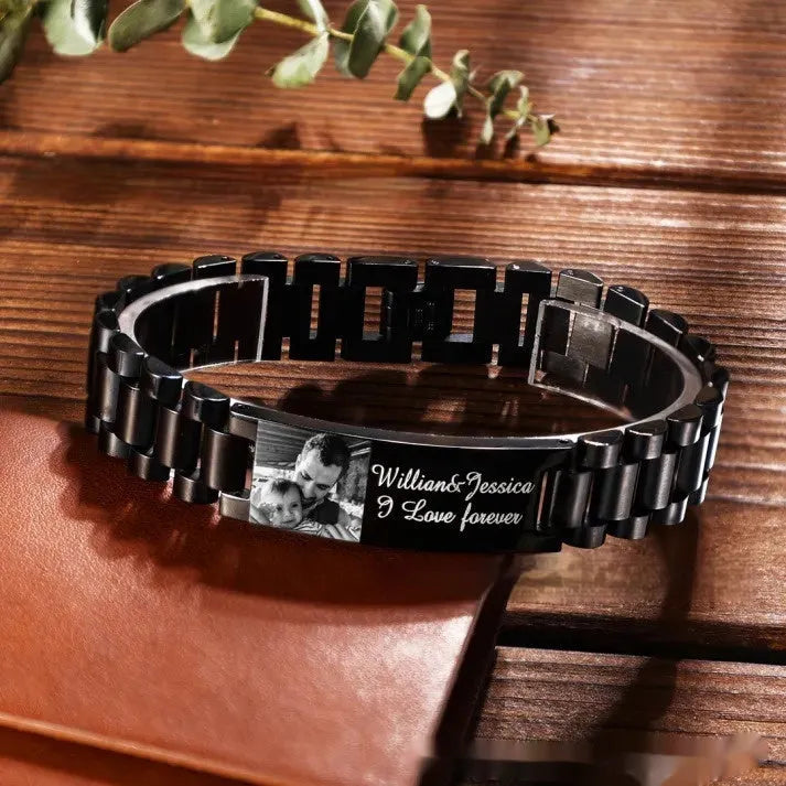 Men's titanium steel bracelet with curved heart shape and black electroplated lettering on wrist.