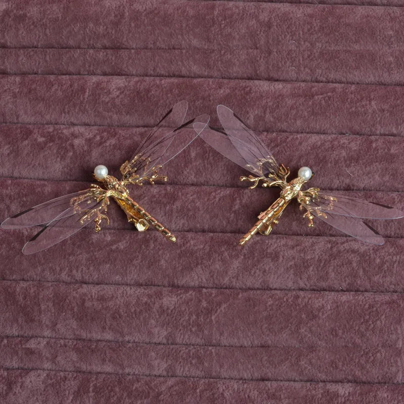 Golden dragonfly-shaped alloy hair clip with electroplated finish and a clip fastening.