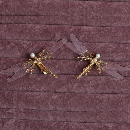 Golden dragonfly-shaped alloy hair clip with electroplated finish and a clip fastening.