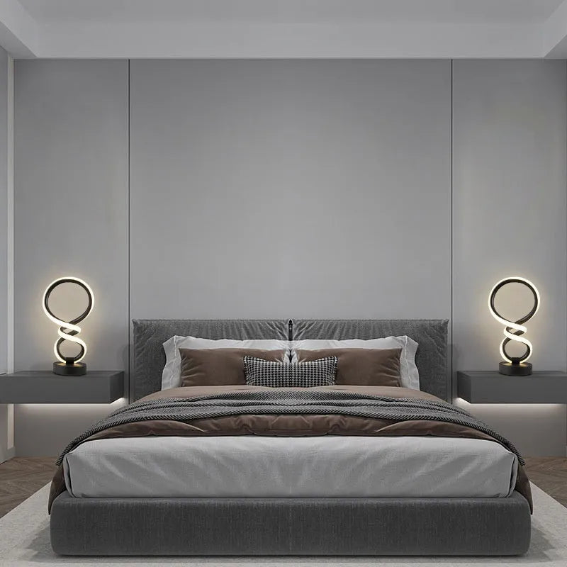 Black remote-controlled LED night light with Bluetooth remote on a bedside table.