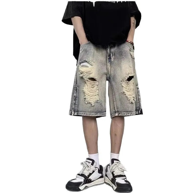 A pair of faded blue denim shorts with a tattered, distressed finish and a loose wide-leg silhouette.